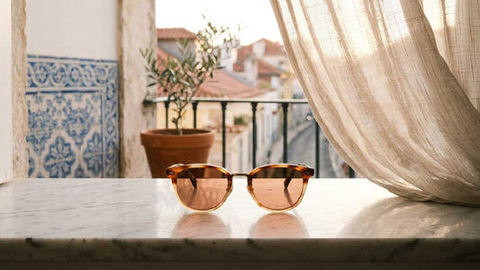 Luxury colored tinted lens sunglasses on a Lisbon marble windowsill, Old Money editorial style